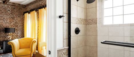 A bathroom with a shower, tiled walls, and a window.