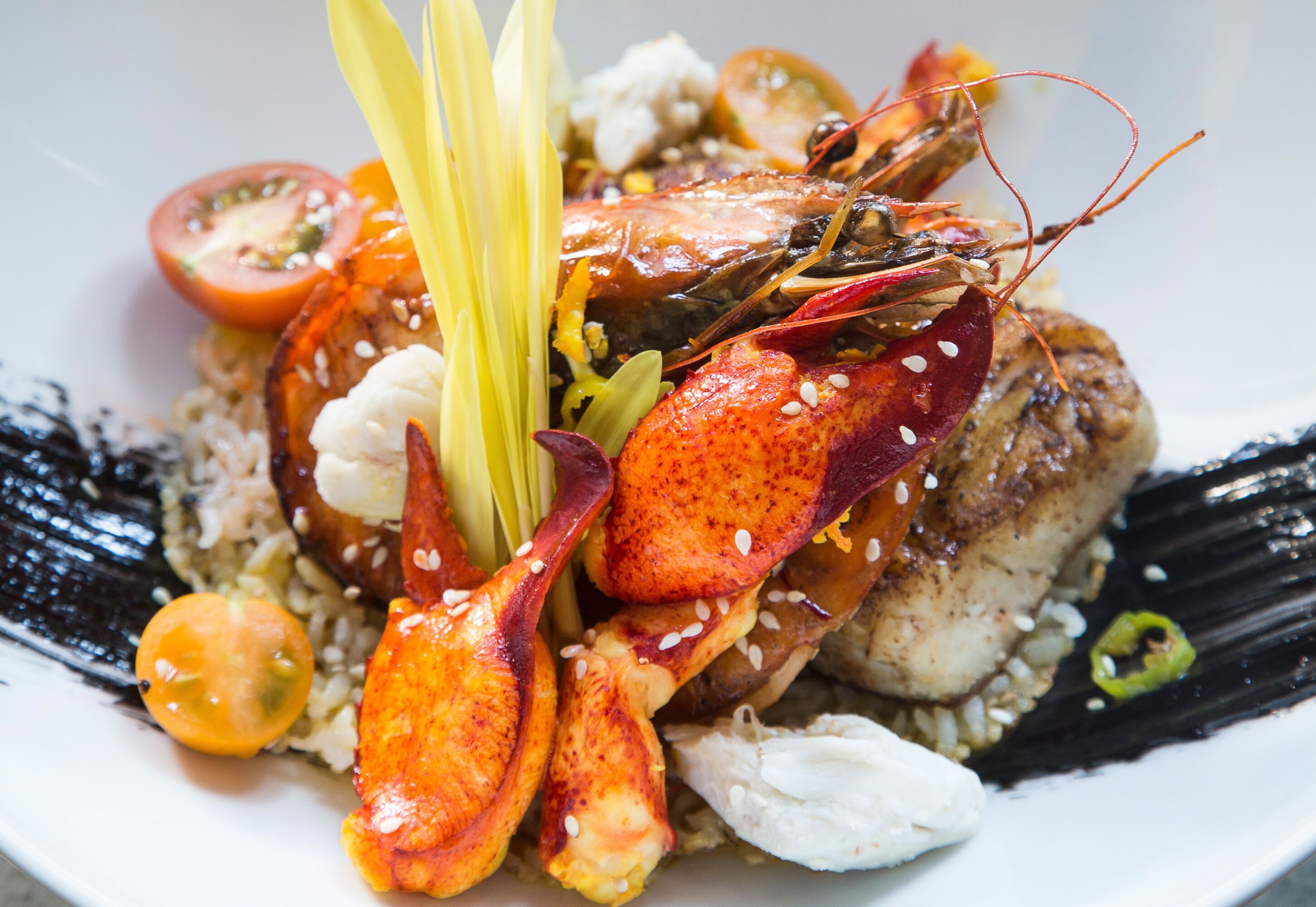 A lobster dish with rice and vegetables.
