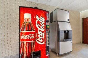 A vending machine with a Coca-Cola logo and a water dispenser. - Red Roof Inn Staunton (Staunton)
