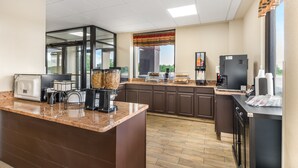 A modern kitchen with granite countertops, a coffee station, and a view of the outdoors. - Red Roof Inn Staunton (Staunton)