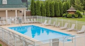 Seasonal outdoor pool, open 9:00 AM to 9:00 PM, pool umbrellas