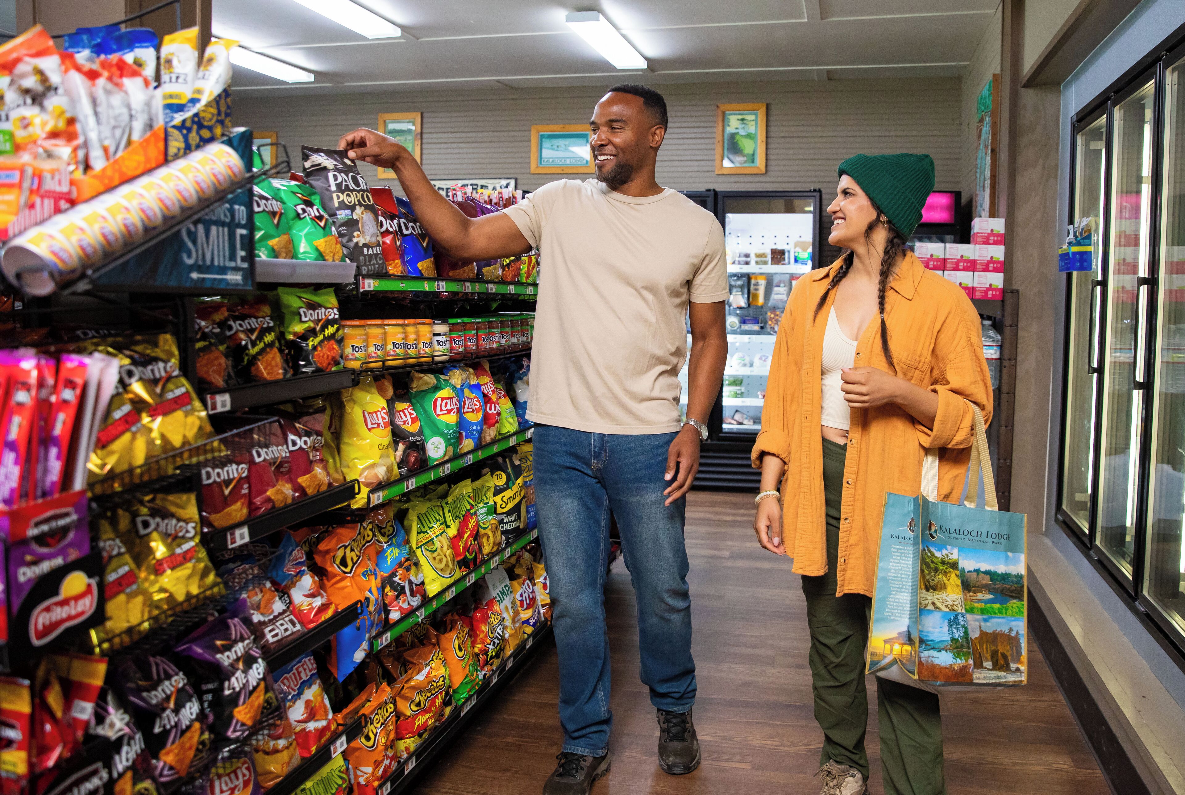 A grocery aisle with various snack brands.