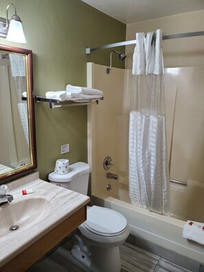 A bathroom with a toilet, sink, and shower. - Super 8 by Wyndham Shelton (Shelton)
