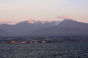 A coastal view with mountains in the background and a marina with boats. - Super 8 by Wyndham Port Angeles at Olympic National Park (Port Angeles)