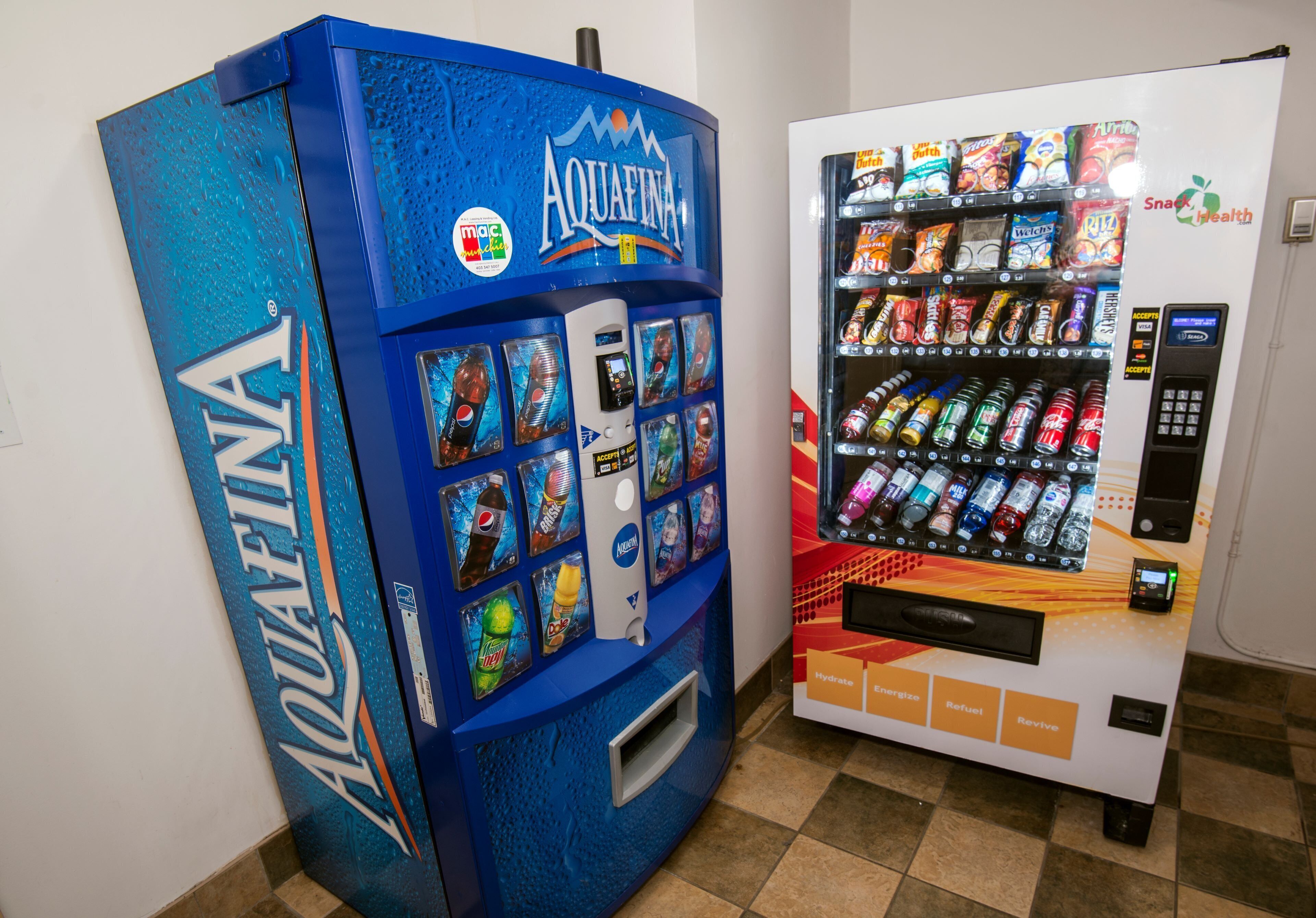 Two vending machines, one labeled AQUAFINA and the other with various snacks and drinks.
