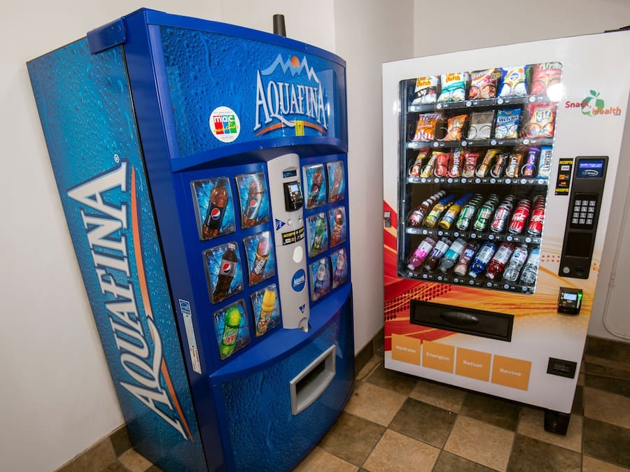Two vending machines, one labeled AQUAFINA and the other with various snacks and drinks.