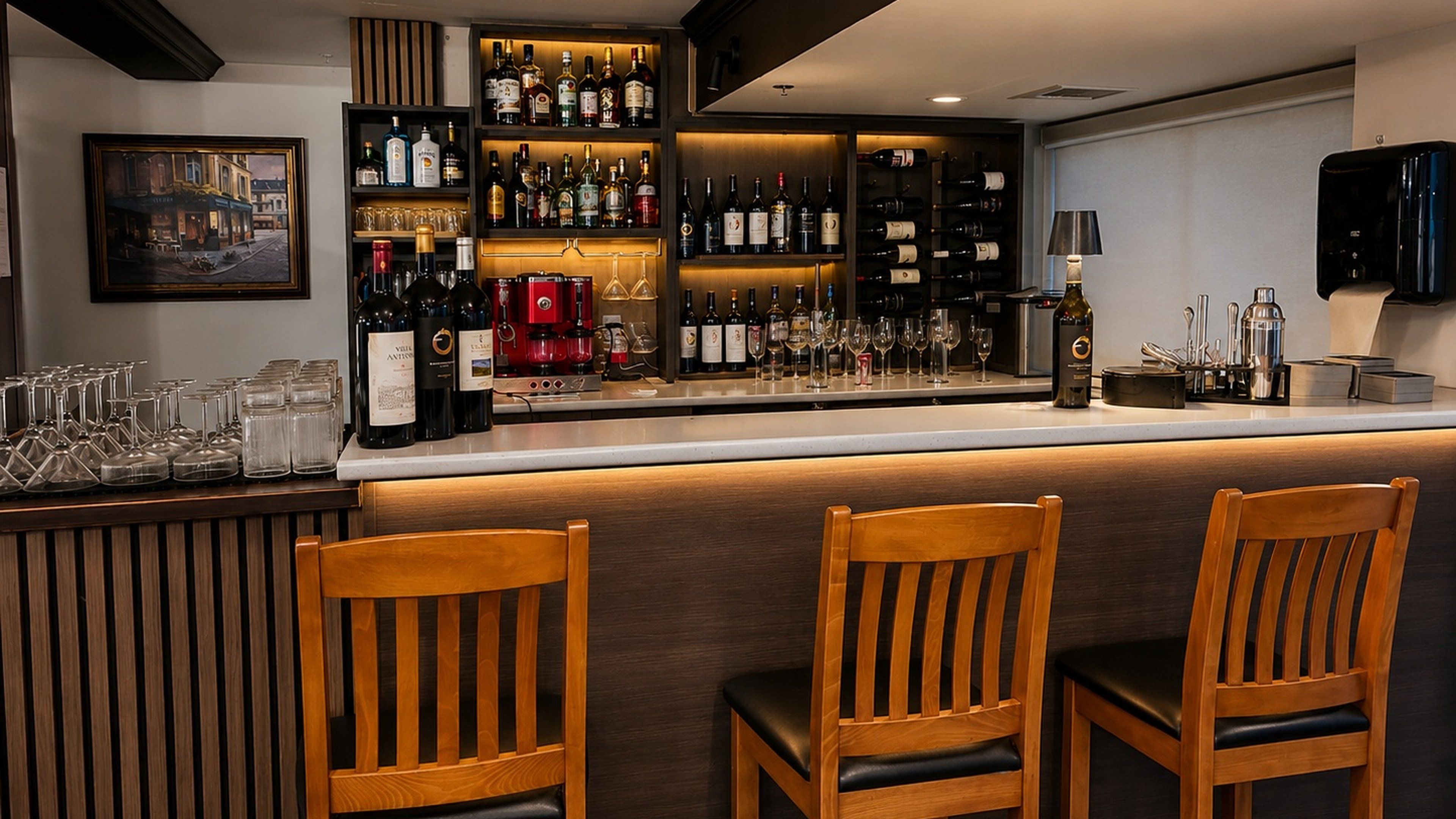 A bar area with wooden chairs, a wine rack, and a coffee machine.