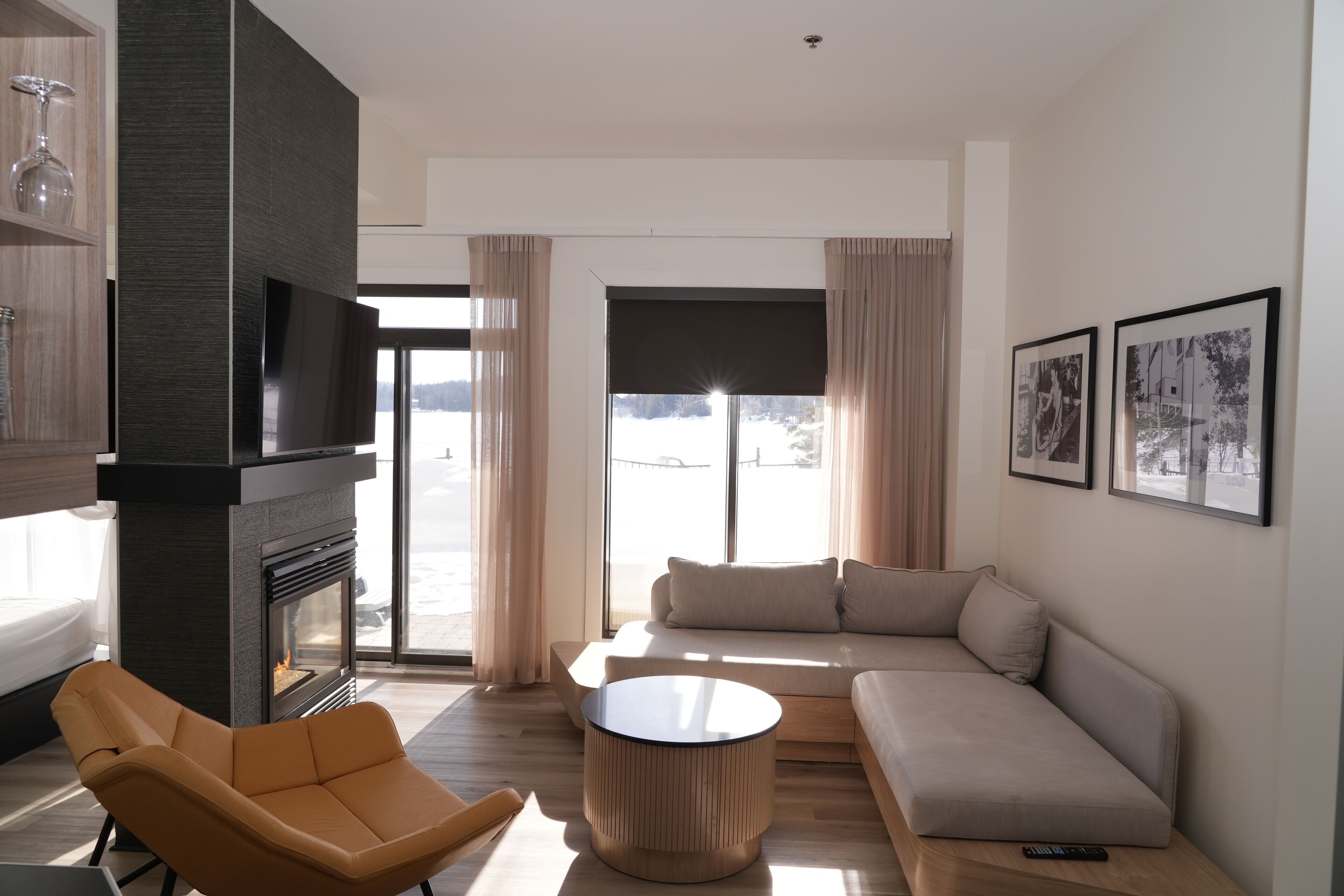 A modern living room with a fireplace, a sofa, a chair, and a coffee table.