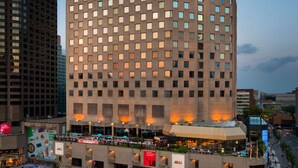 A modern hotel with a grid of windows and a rooftop terrace. - DoubleTree by Hilton Montreal (Montreal)