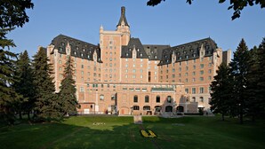 A large, historic building with a symmetrical facade, multiple windows, and a central tower. - Delta Hotels by Marriott Bessborough (Saskatoon)