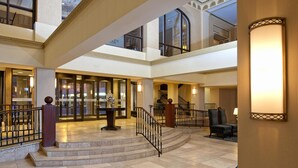 A spacious lobby with a grand staircase, multiple levels, and a reception area. - Delta Hotels by Marriott Bessborough (Saskatoon)