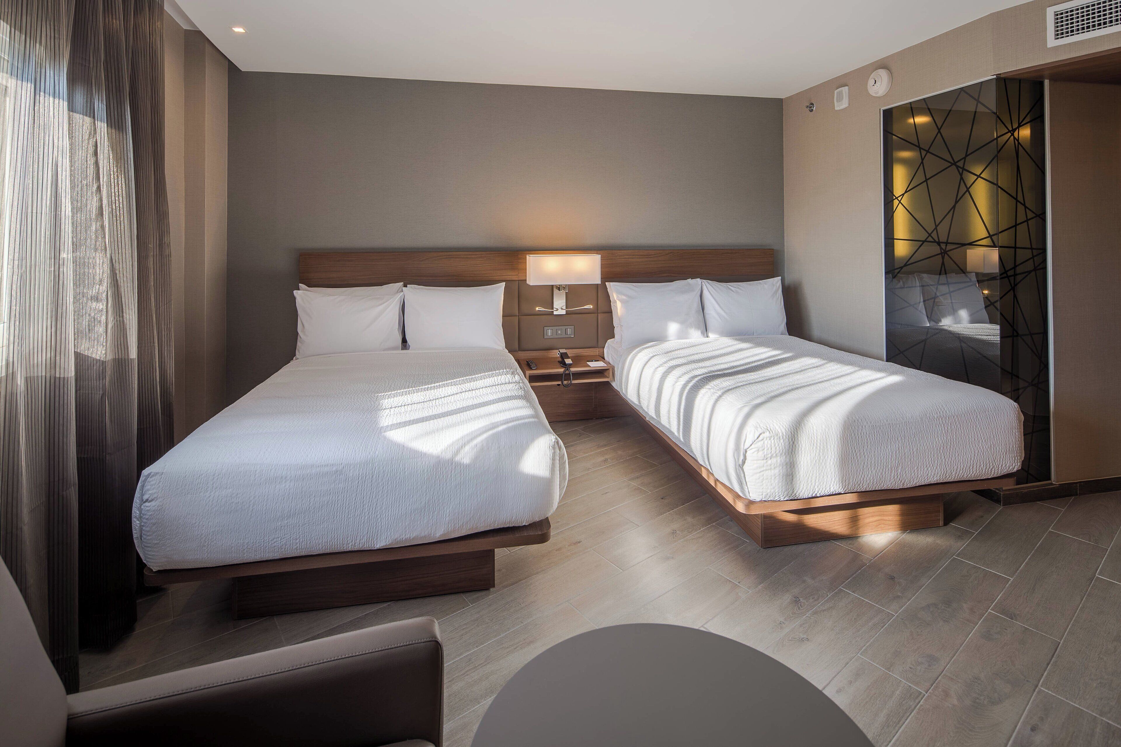 room, 2 double beds, city view | in-room safe, desk, laptop workspace, blackout curtains