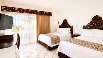 A hotel room with two beds, a TV, a bedside table, and a window with curtains.