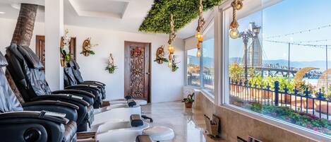 A spa with massage chairs, a wooden door, and a view of a bridge.