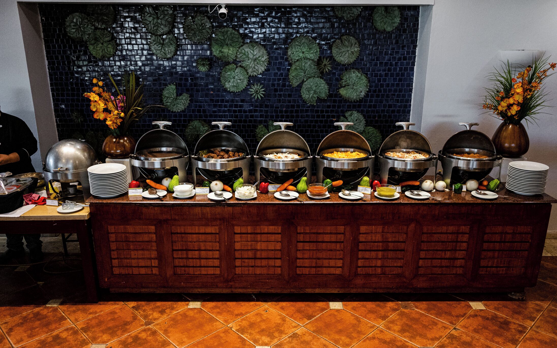 A buffet with various food items and condiments.