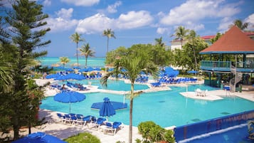 Outdoor pool, pool loungers, lifeguards on site