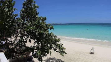On the beach, sun loungers, beach towels, beach bar