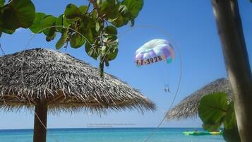 On the beach, sun-loungers, beach towels, beach bar