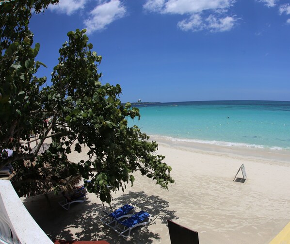 On the beach, sun loungers, beach towels, beach bar