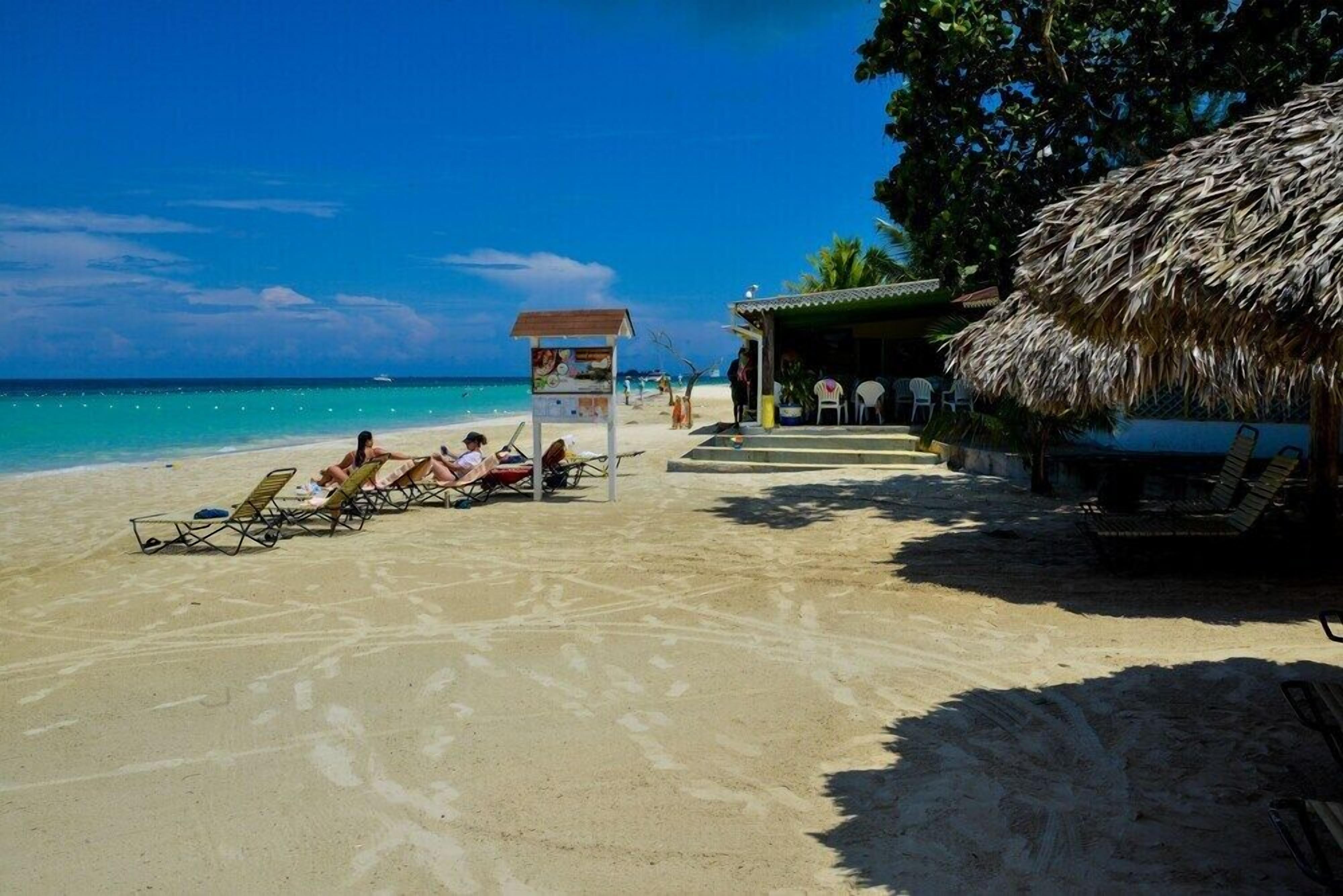 On the beach, sun-loungers, beach towels, beach bar