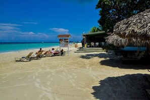 On the beach, sun-loungers, beach towels, beach bar