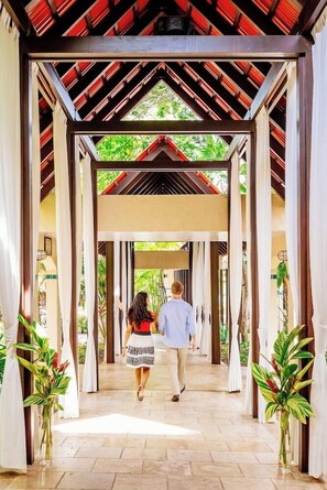 A covered walkway with a tiled floor, leading to a building entrance. - Carambola Beach Resort St. Croix, US Virgin Islands (Kingshill)