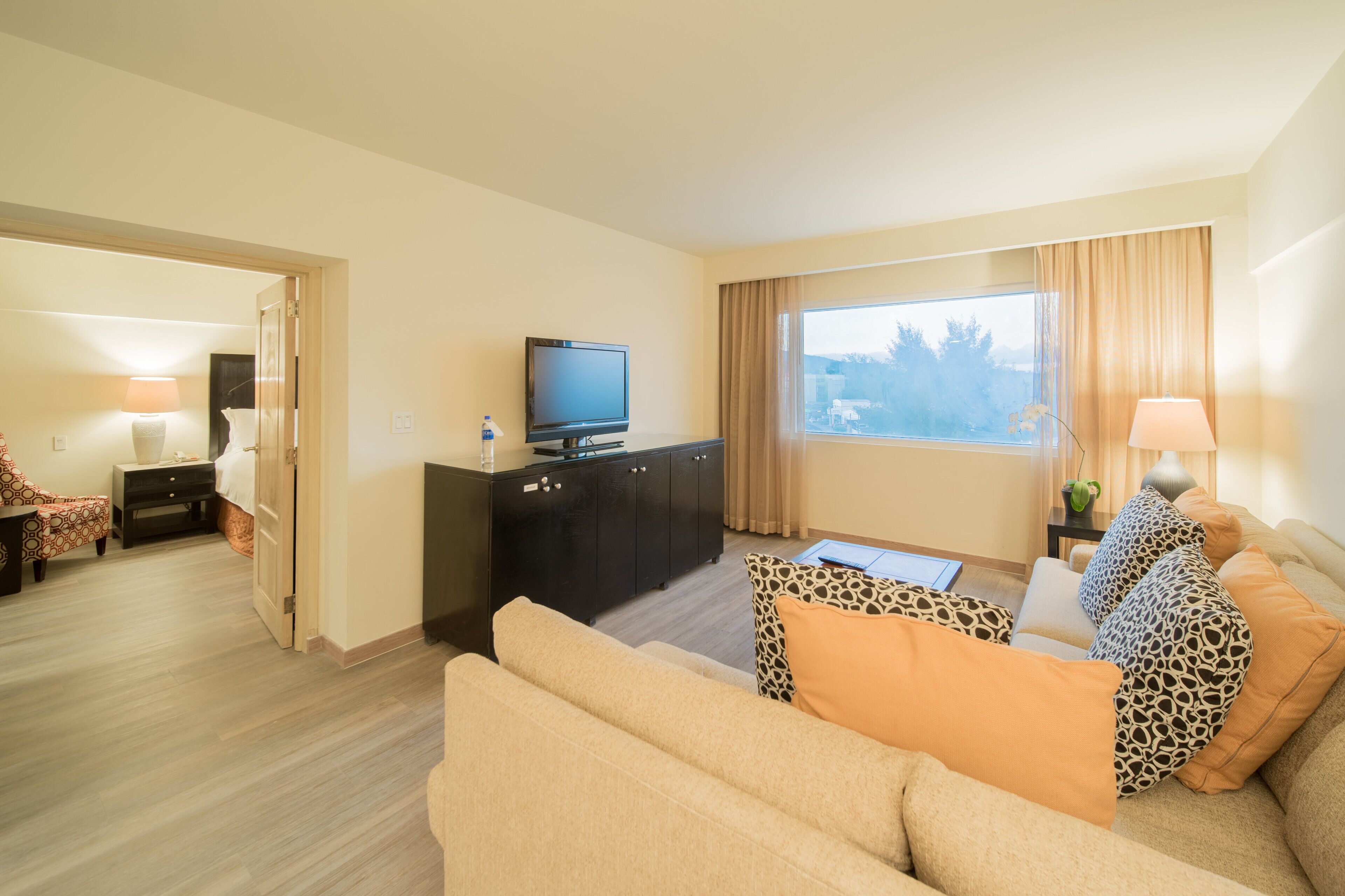 junior suite, 1 king bed | living room | 39-inch lcd tv with cable channels, tv, ipod dock