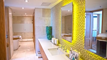 Deep soaking tub, rainfall showerhead, eco-friendly toiletries