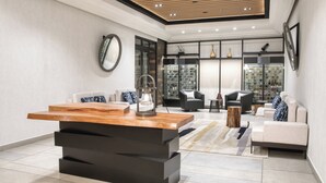 A modern living room with a wooden coffee table, black sofa, and a glass cabinet filled with bottles. - Real InterContinental San Salvador at Metrocentro Mall by IHG (San Salvador)