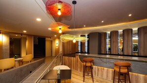 A modern interior with a bar area, seating, and a staircase. - Best Western Plus Hotel Terraza (San Salvador)