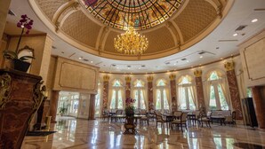 A spacious lobby with a high ceiling, ornate columns, and a large chandelier. - The Westin Camino Real, Guatemala (Guatemala City)