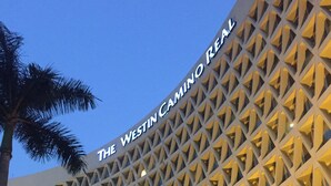 A modern building with a geometric facade and the text "The Westin Camino Real" at the top.