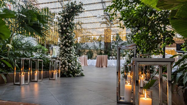An indoor venue with a marble floor, floral decorations, and candle-lit tables. - The Westin Camino Real, Guatemala (Guatemala City)