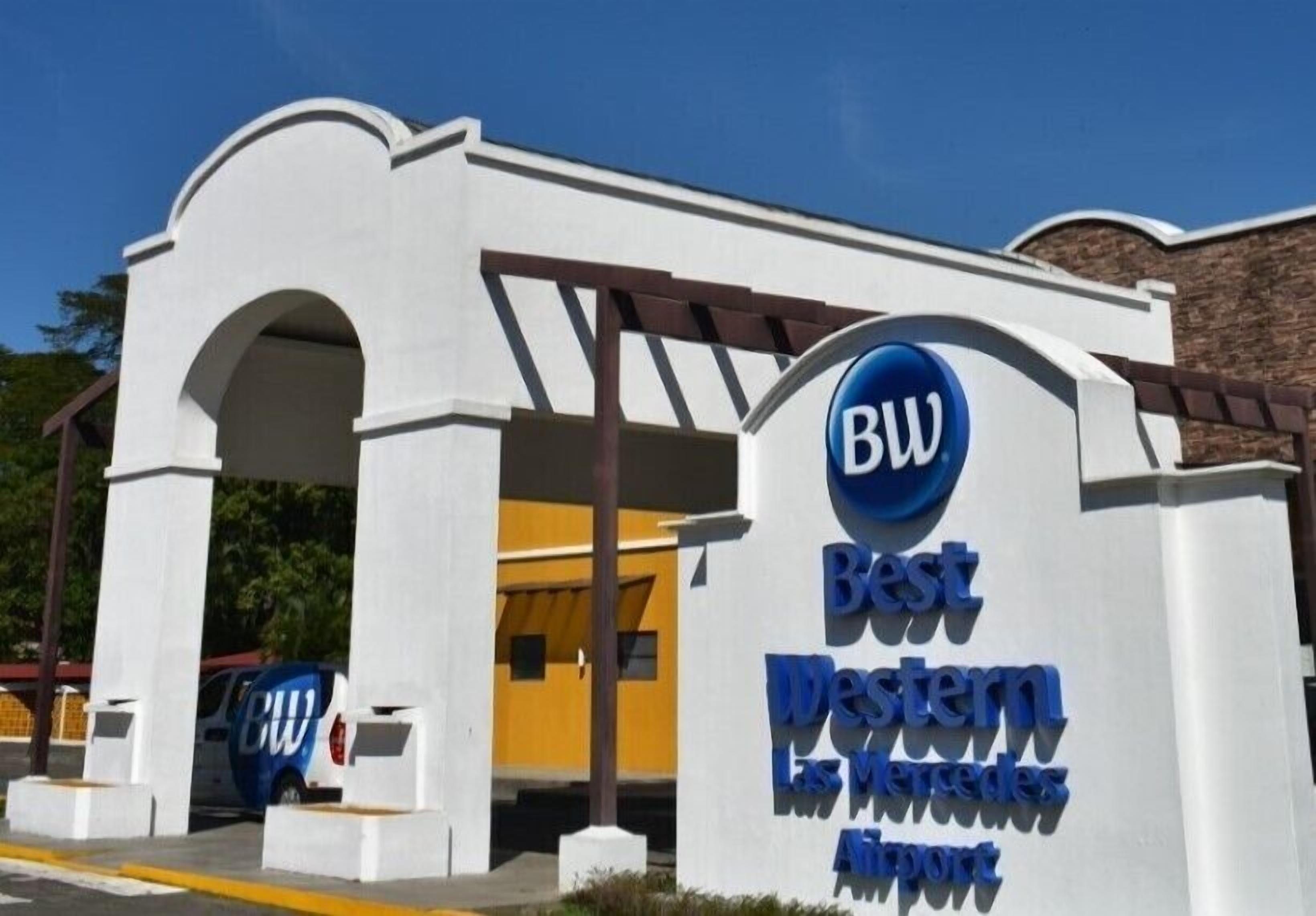 A Best Western sign at an airport entrance.