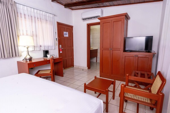 A hotel room with a bed, desk, chair, television, and wardrobe. - Best Western Las Mercedes Airport (Managua)