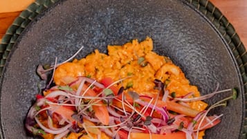 A bowl of food with a textured dark bowl.