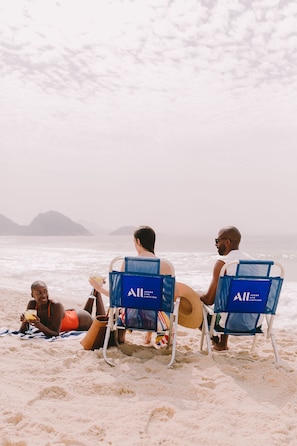 On the beach, white sand, beach umbrellas, beach towels