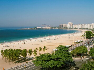 Aan het strand, wit zand, parasols, strandlakens