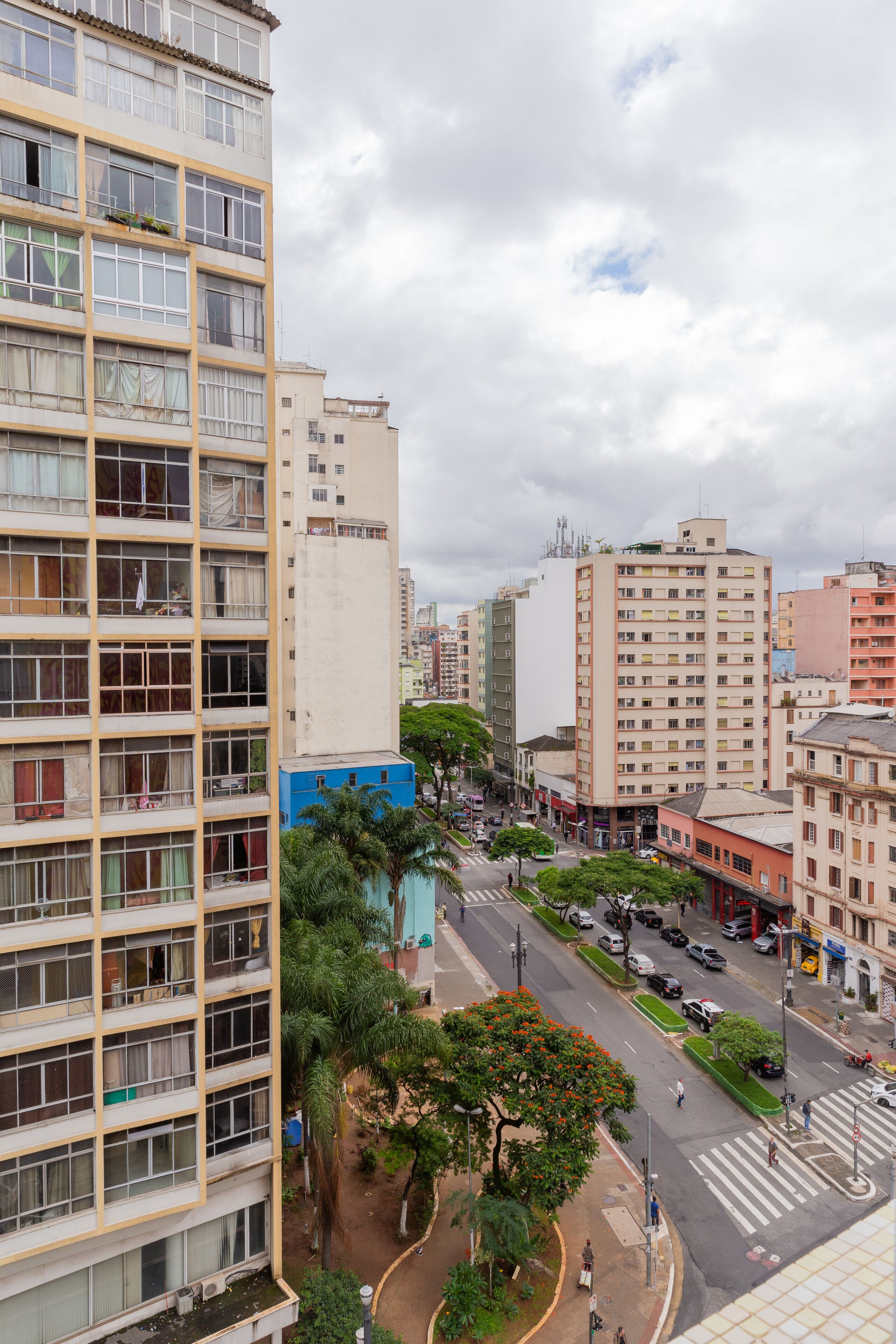 A multi-story building with balconies and a street view.