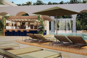 Zona de piscina con sillones de descanso, una cascada y un área de estar techada con sillas de mimbre.