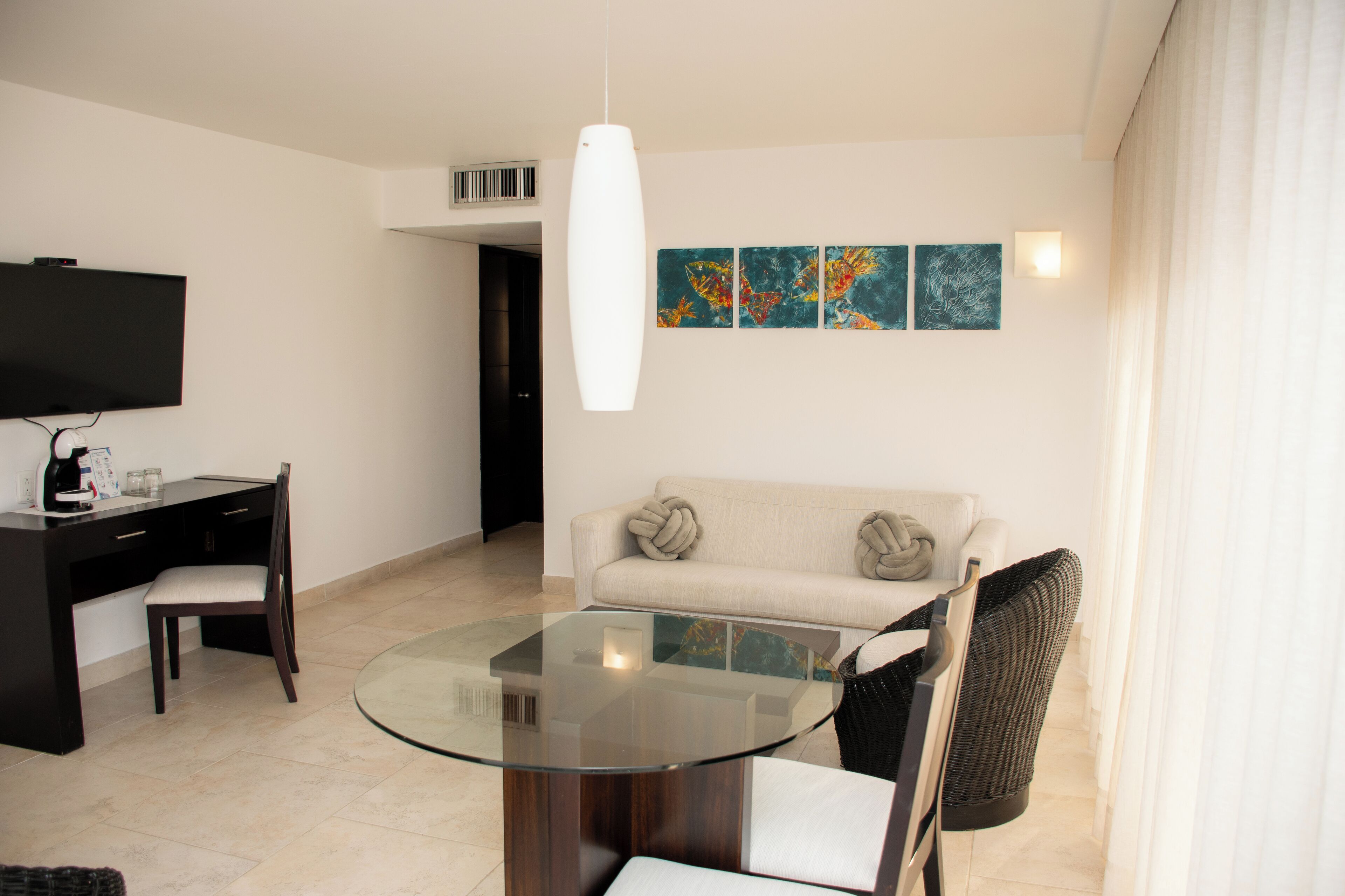junior suite, balcony, ocean view | living area | 42-inch tv with cable channels