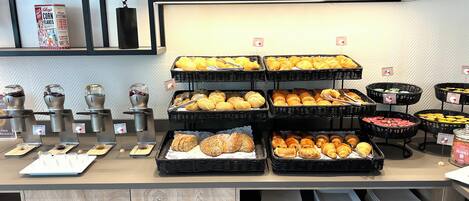 A buffet with various food items and a coffee station.