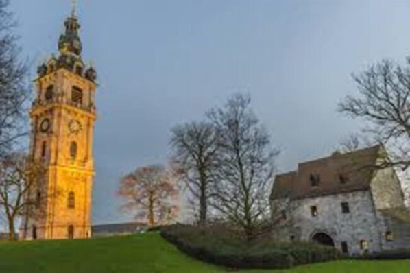 A historic building with a clock tower and a stone structure.