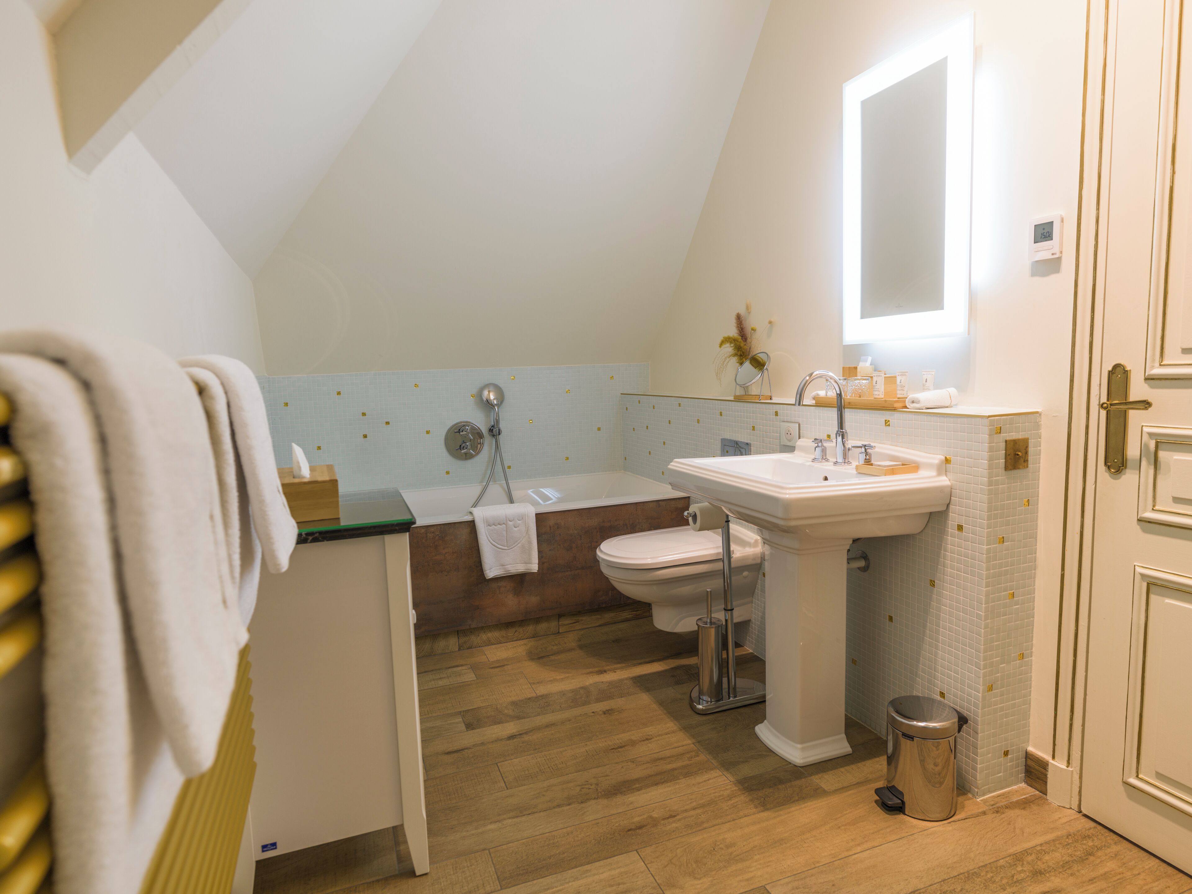 A bathroom with a toilet, sink, and shower.