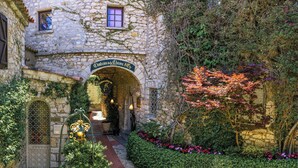 A stone building with an archway labeled "Château de Chevre d'Or". - Château de La Chèvre d’Or (Èze)