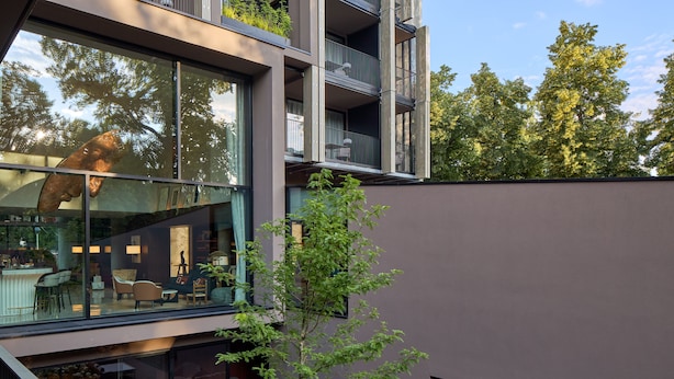 A modern building with large windows, a balcony, and a small tree in front. - L'Esquisse Hotel & Spa Colmar - MGallery Collection (Colmar)