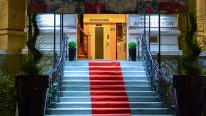 The entrance to Concordia Hotel with a red carpet leading up the stairs.