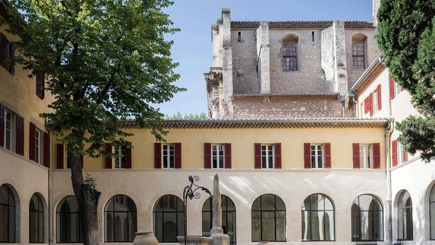 A courtyard with a central fountain, surrounded by arched windows and a building with red shutters. - Jules César Hotel & Spa Arles - MGallery Collection (Arles)