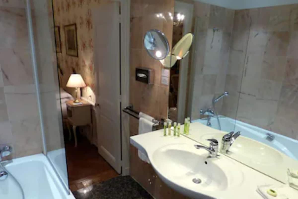 combined shower/bathtub, designer toiletries, hair dryer, bathrobes