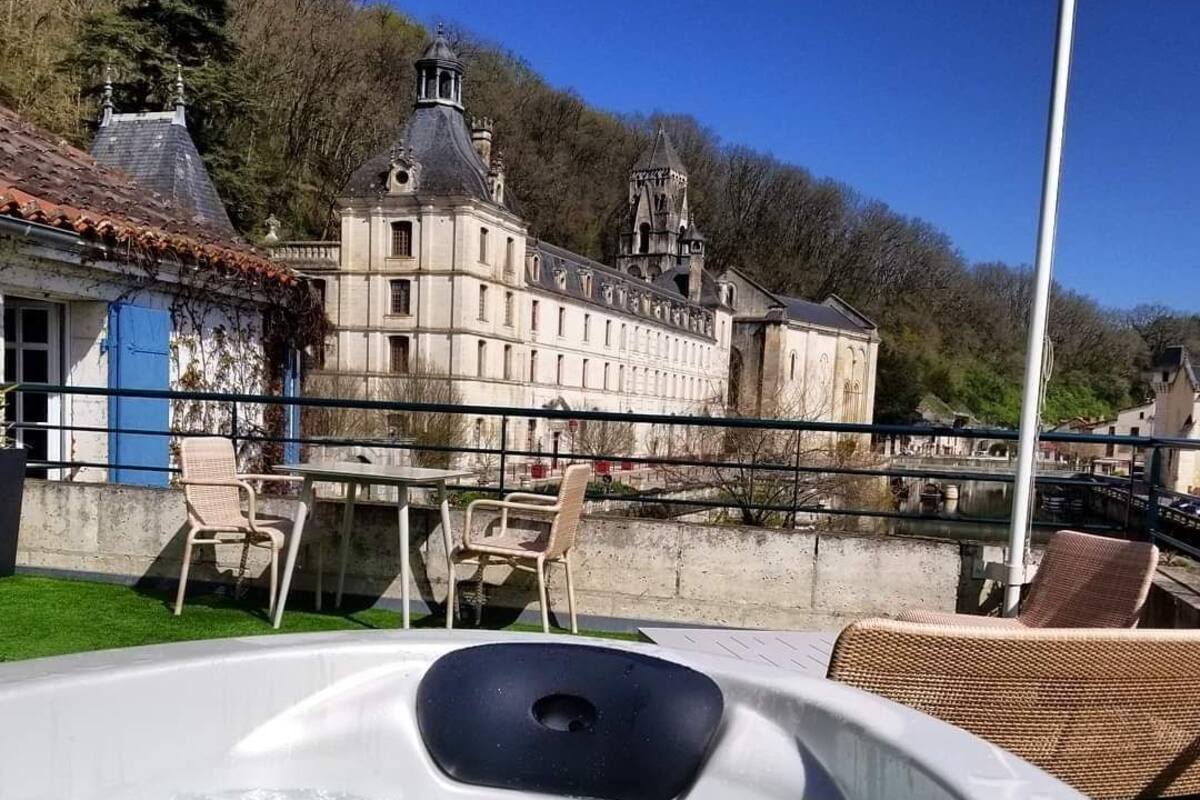 A hot tub with a view of a historic building in the background.